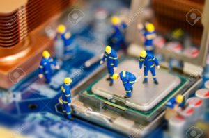 13646653-Miniature-workers-repairing-computer-motherboard-Stock-Photo-repair