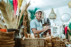 Smiling,Man,Holds,The,Clipboard,While,List,Items,Among,Craft